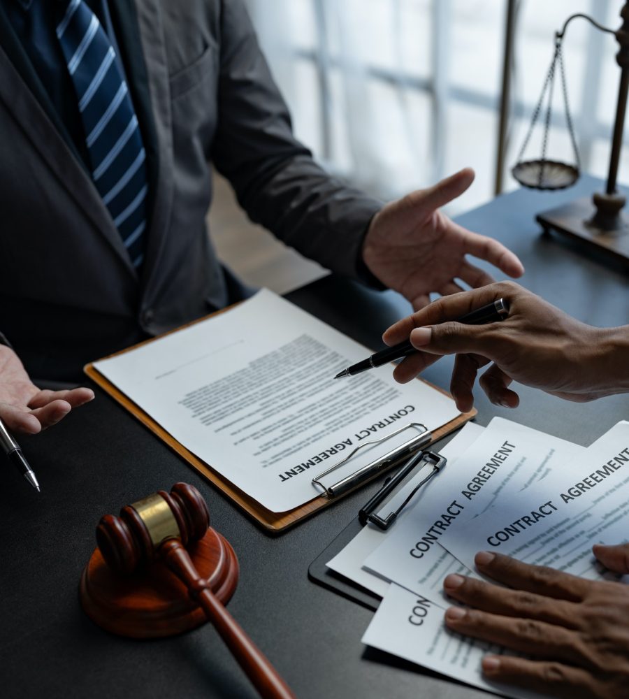 Attorneys or lawyer reading statute of limitations, consulting between male lawyers and business cli